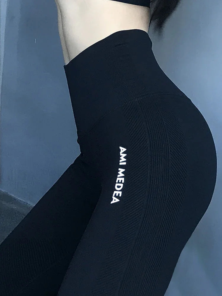 High waist black seamless leggings with textured design and AMI MEDEA logo